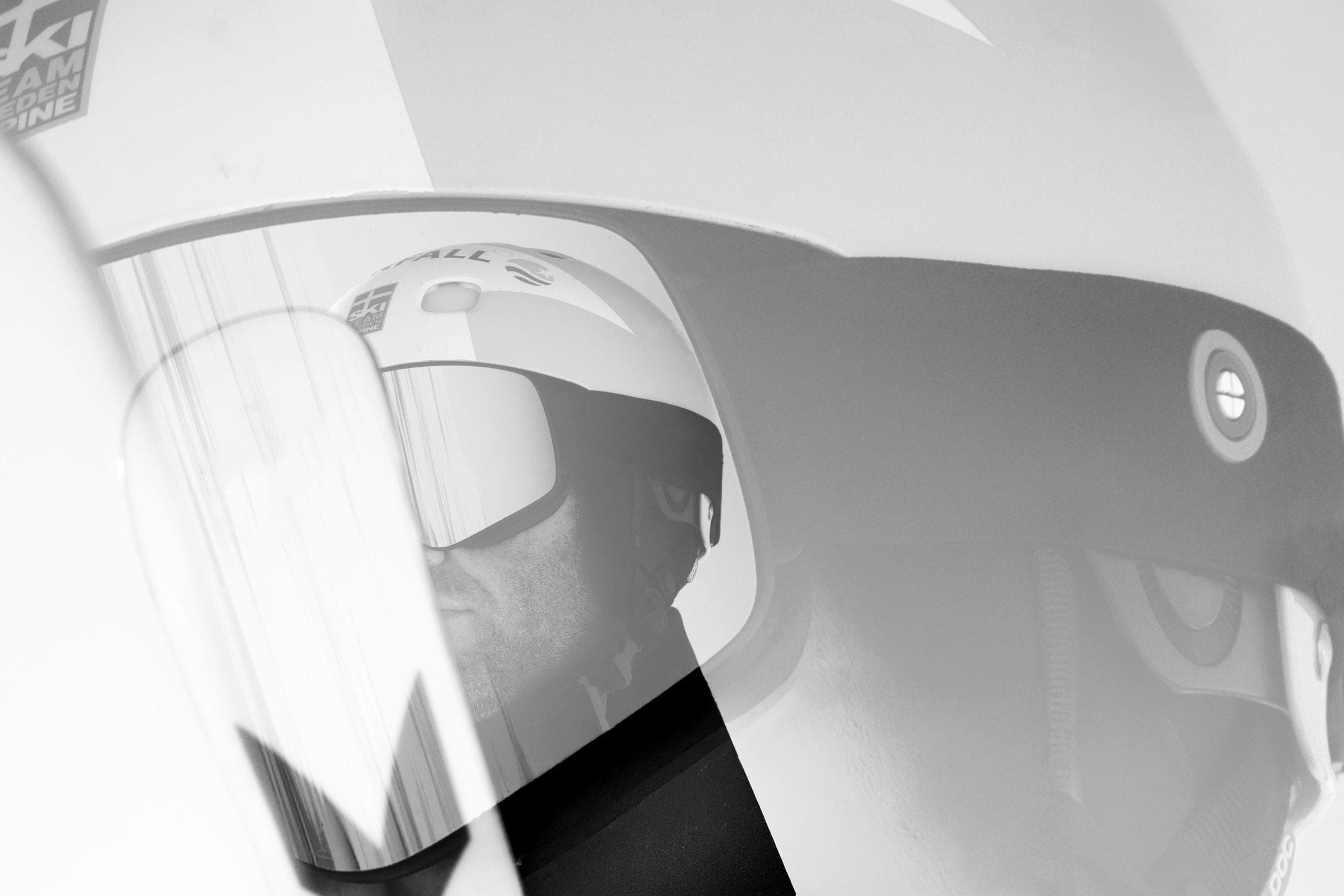 Close-up of a ski helmet and goggles, black and white